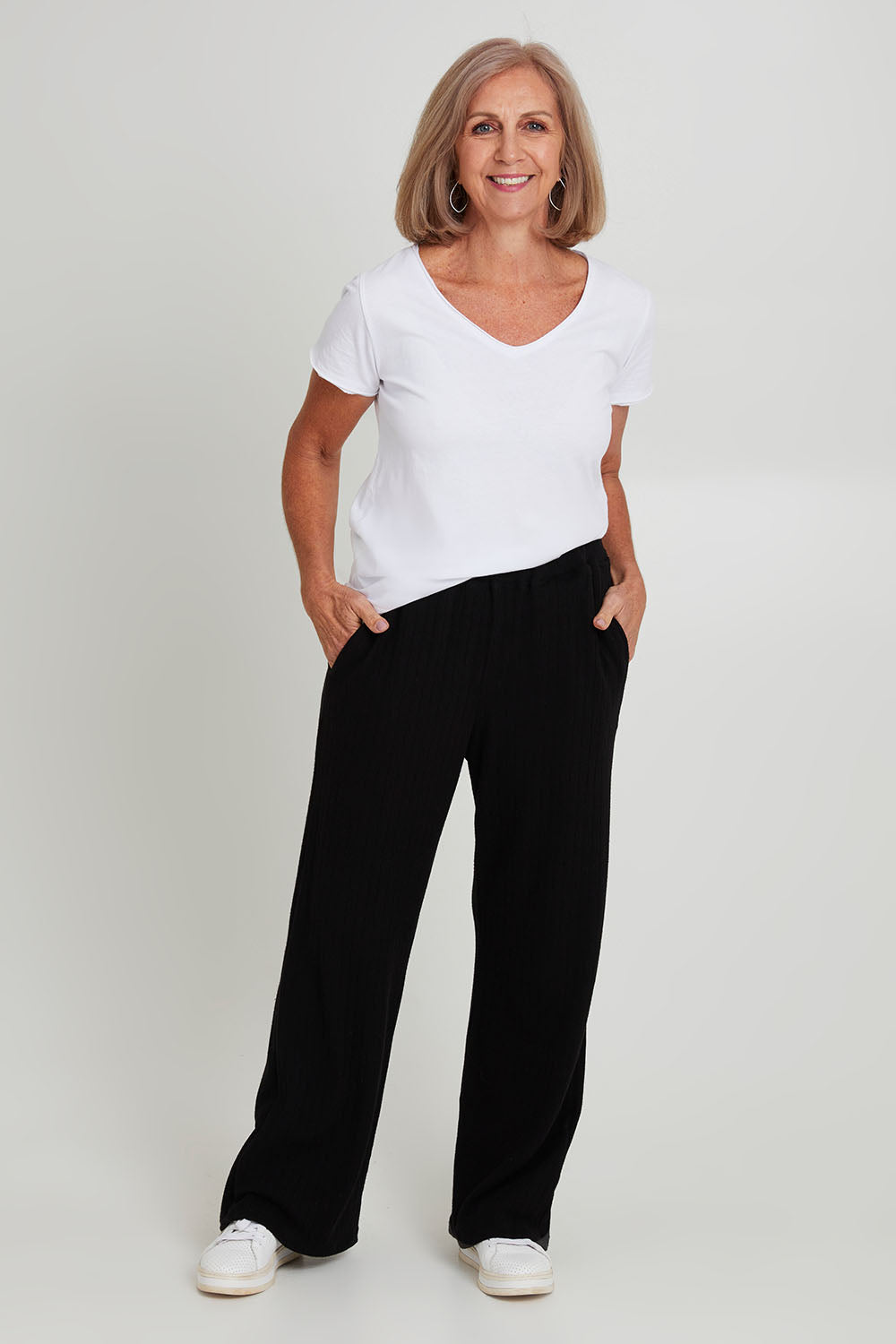 Model Sandy wearing size 10 of the Rachel Rib Pant in colour Black (Black), from the front, showing the whole outfit