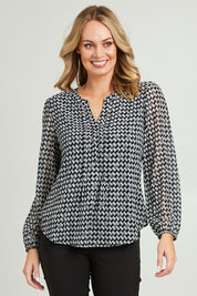Model Grace wearing size 10 of the Chiffon Pintuck Top in colour Check (Black), from the front, cropped image