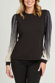 Model Grace wearing size 10 of the Contrast Pleat Top in colour Black (Black), from the front, cropped image