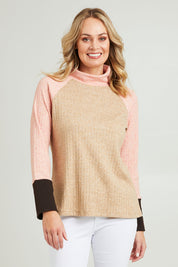 Model Grace wearing size 10 of the Spliced Cowl Rib Top in colour Coral, from the front, cropped image