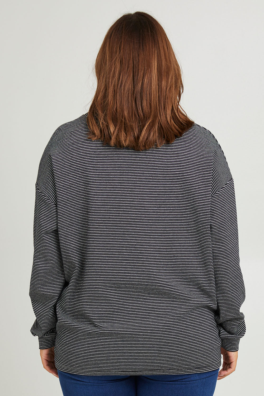 Model Monique wearing size 14 of the Oversized Loose Cowl Top in colour Black (Black), from the back