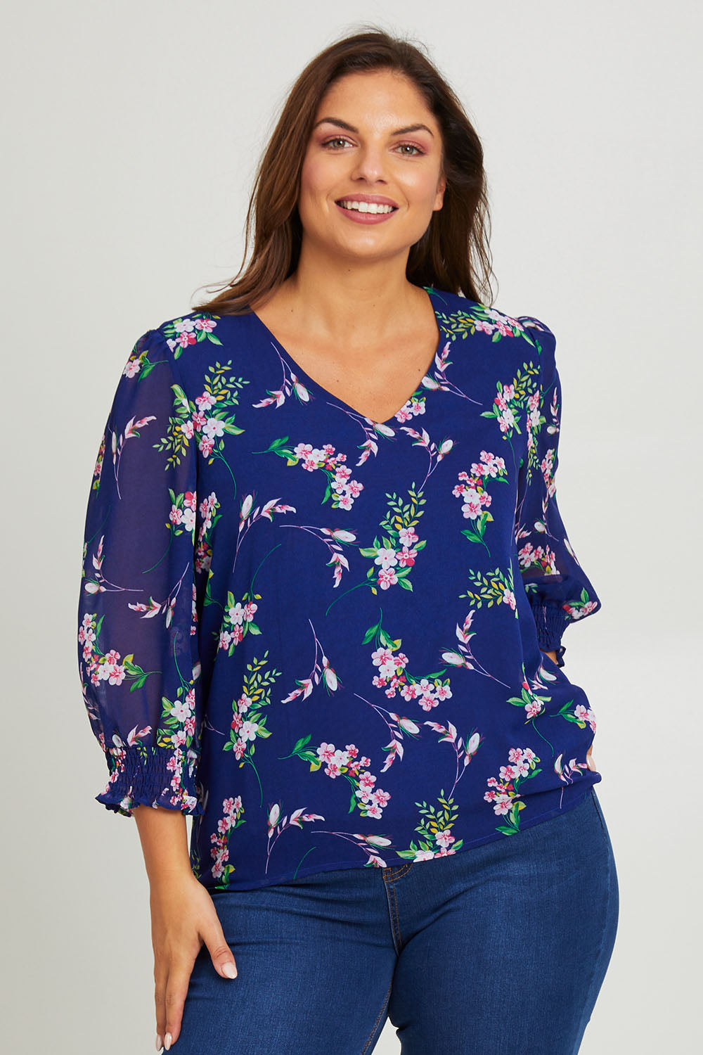 Model Monique wearing size 14 of the Felicity Chiffon Top in colour Blue (Blue), from the front, cropped image