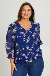 Model Monique wearing size 14 of the Felicity Chiffon Top in colour Blue (Blue), from the front, cropped image