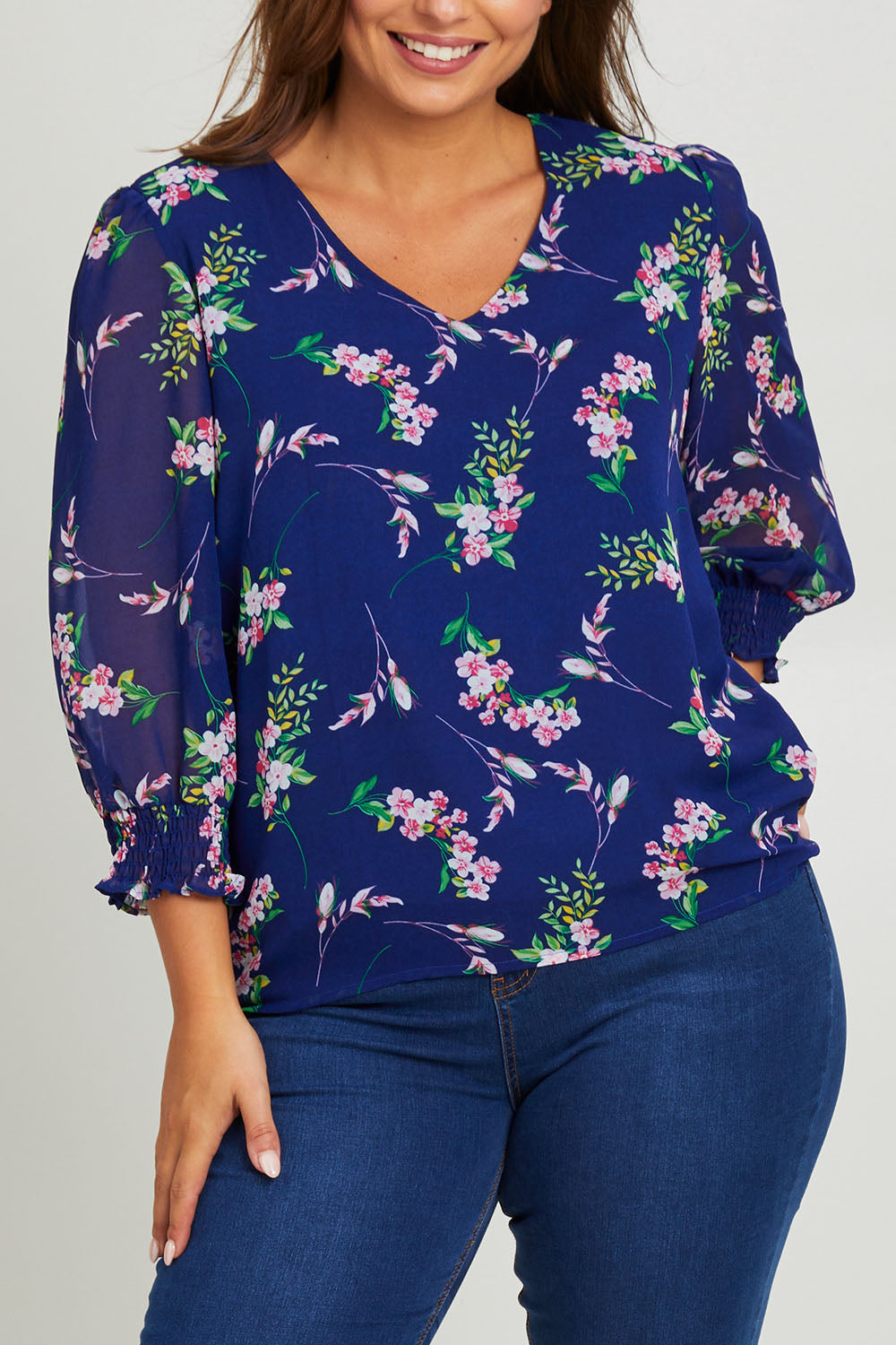 Model Monique wearing size 14 of the Felicity Chiffon Top in colour Blue (Blue), from the front, cropped image