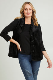 Model Grace wearing size 10 of the Unreal Core Vest in colour Black (Black), from the front, cropped image