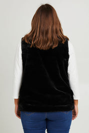 Model Monique wearing size 14 of the Unreal Core Vest in colour Black (Black), from the back