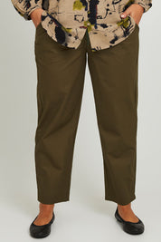 Model Monique wearing size 14 of the Cotton Cargo Pant in colour Khaki (Green), from the front, cropped image