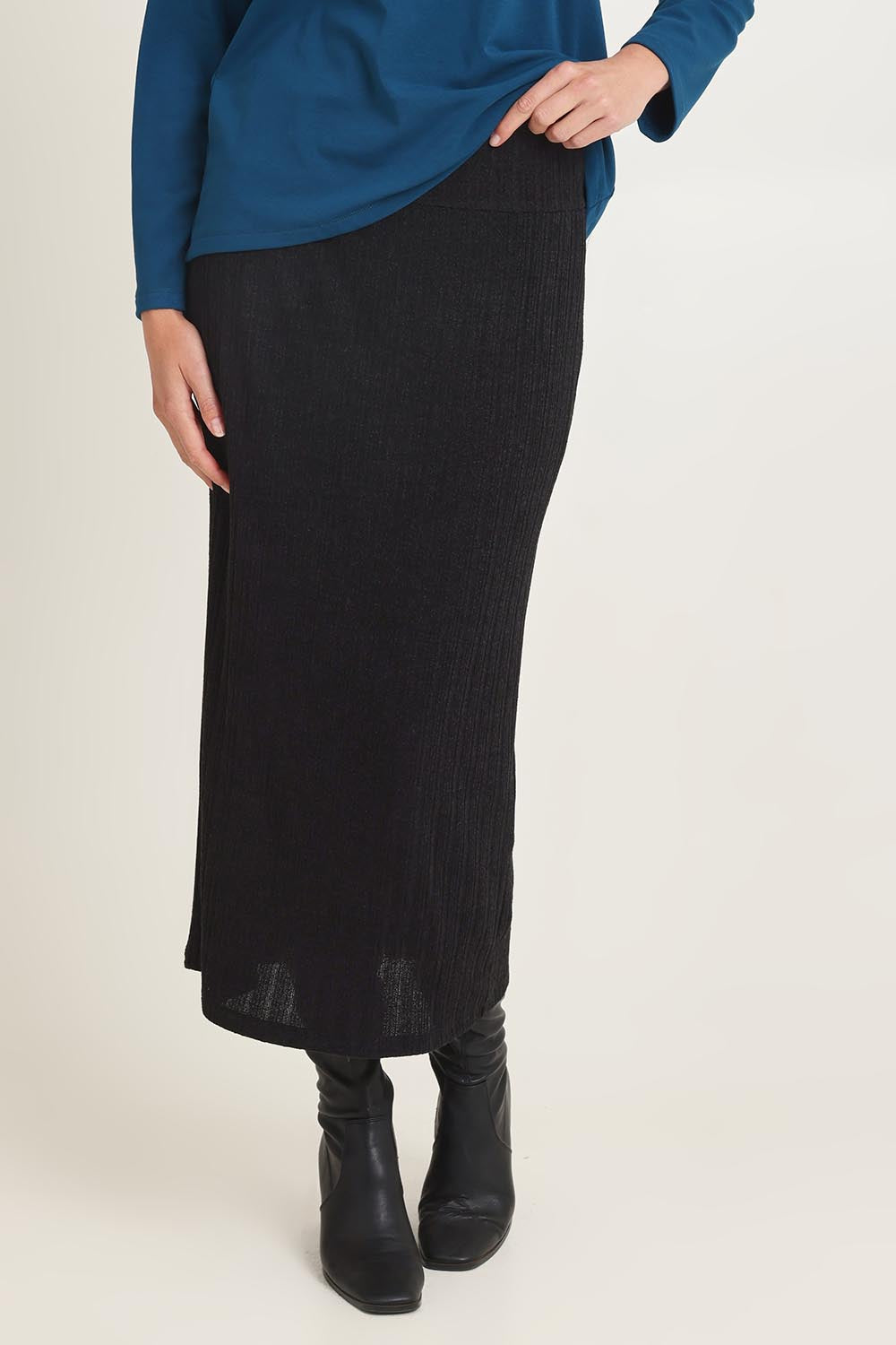 Model Madeline wearing size 10 of the Knit Core Skirt in colour Black (Black), from the front, cropped image