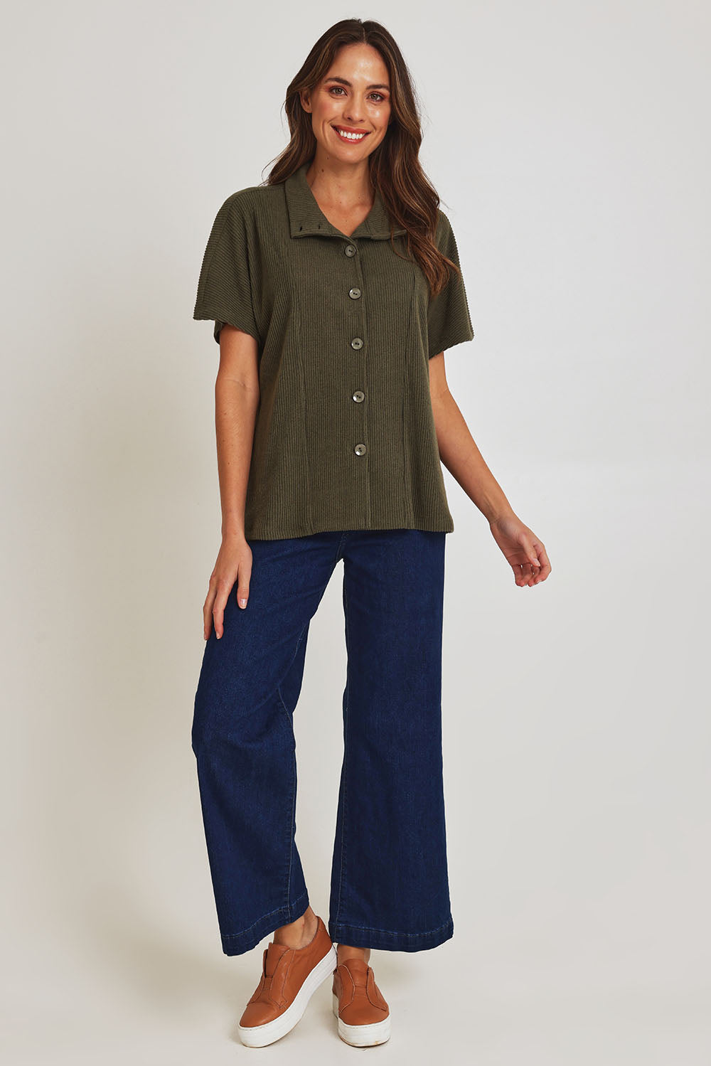 Model Madeline wearing size 10 of the Vesty Top in colour Khaki (Green), from the front, showing the whole outfit