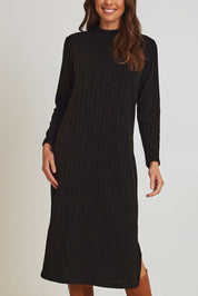 Model Madeline wearing size 10 of the Rib Dress in colour Black (Black), from the front, cropped image