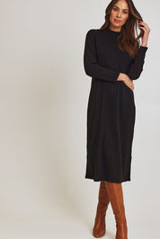 Model Madeline wearing size 10 of the Rib Dress in colour Black (Black), from the front, showing the whole outfit