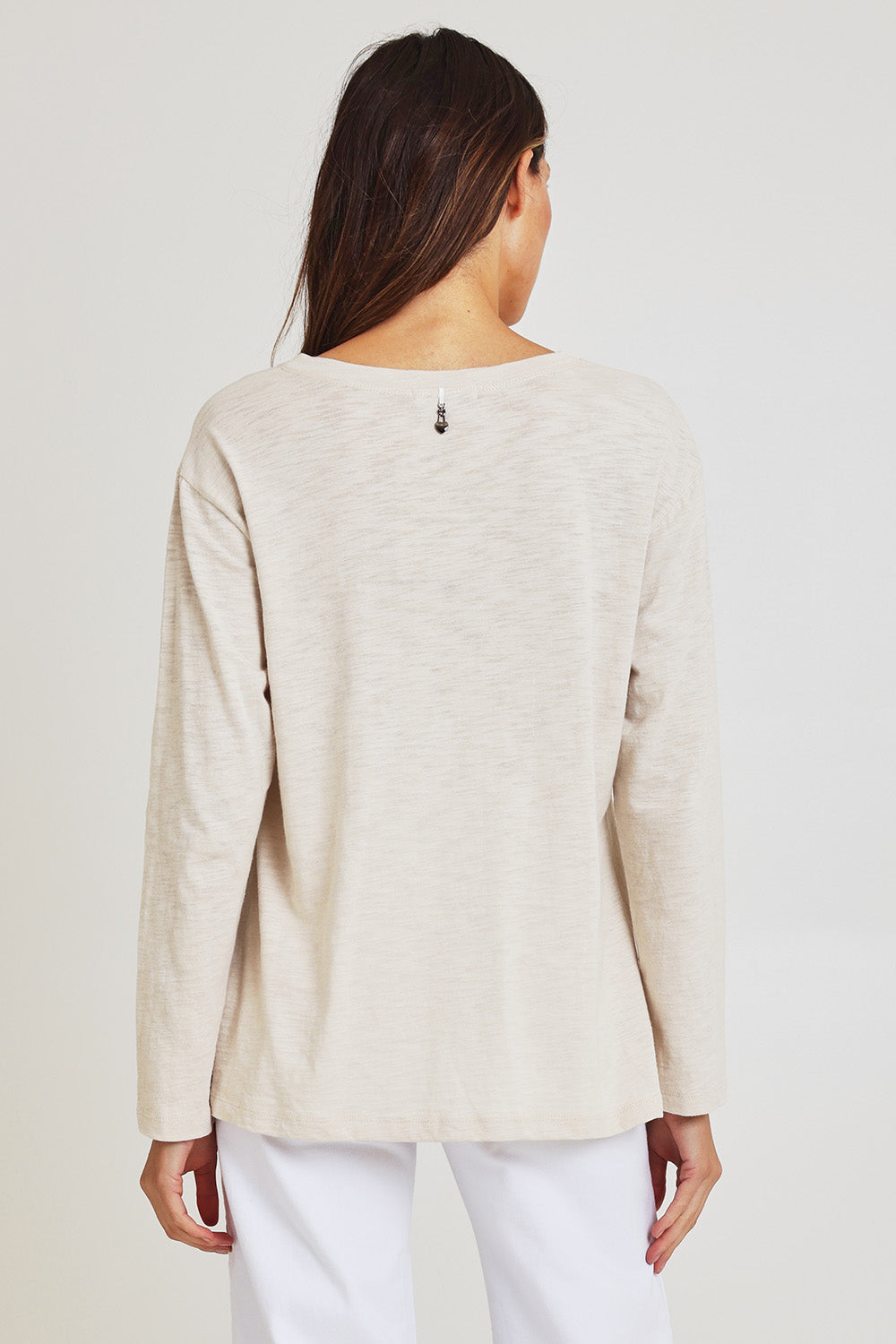 Model Madeline wearing size 10 of the Foiling Around Cotton Tee in colour Oatmeal, from the back