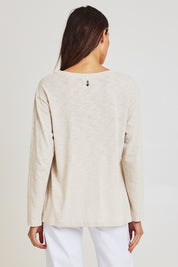 Model Madeline wearing size 10 of the Foiling Around Cotton Tee in colour Oatmeal, from the back