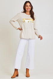 Model Madeline wearing size 10 of the Foiling Around Cotton Tee in colour Oatmeal, from the front, showing the whole outfit