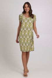 Model Madeline wearing size 10 of the Summer Sands Dress in colour Lime (Green), from the front, showing the whole outfit