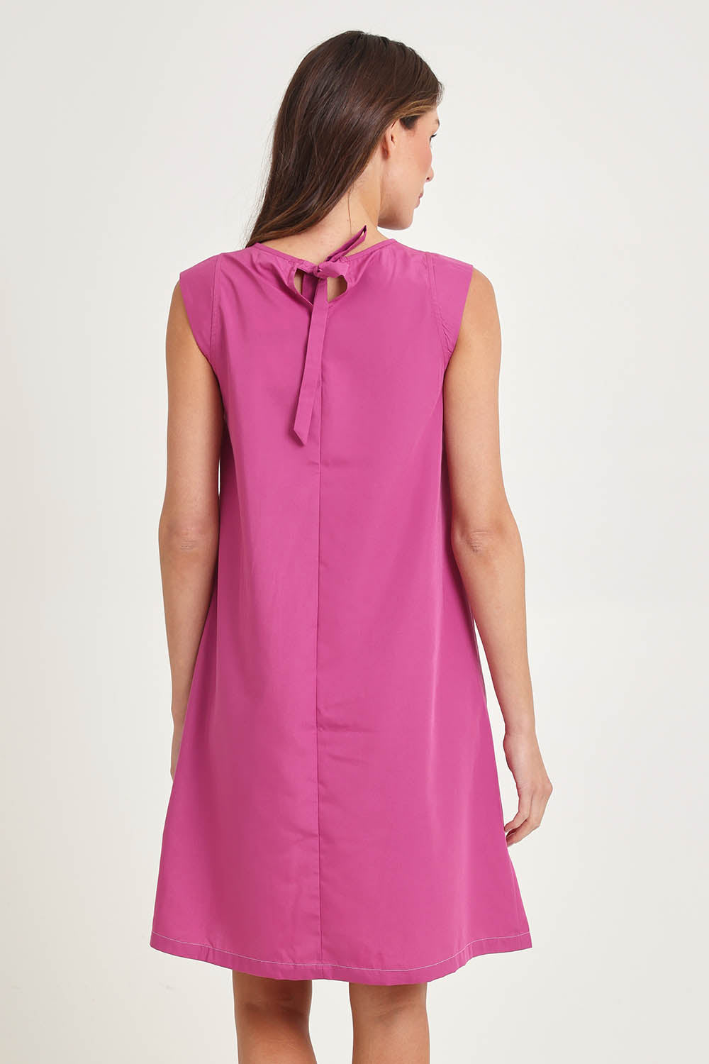 Model Madeline wearing size 10 of the Get Smart Cotton Blend Dress in colour Berry (Pink), from the back