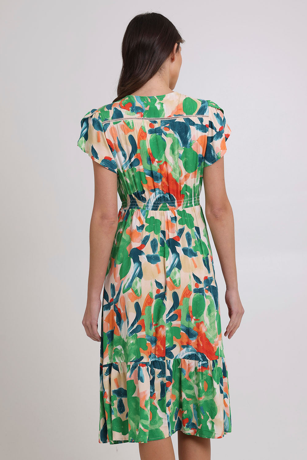 Model Madeline wearing size 10 of the Jilly Dress in colour Green (Green), from the back