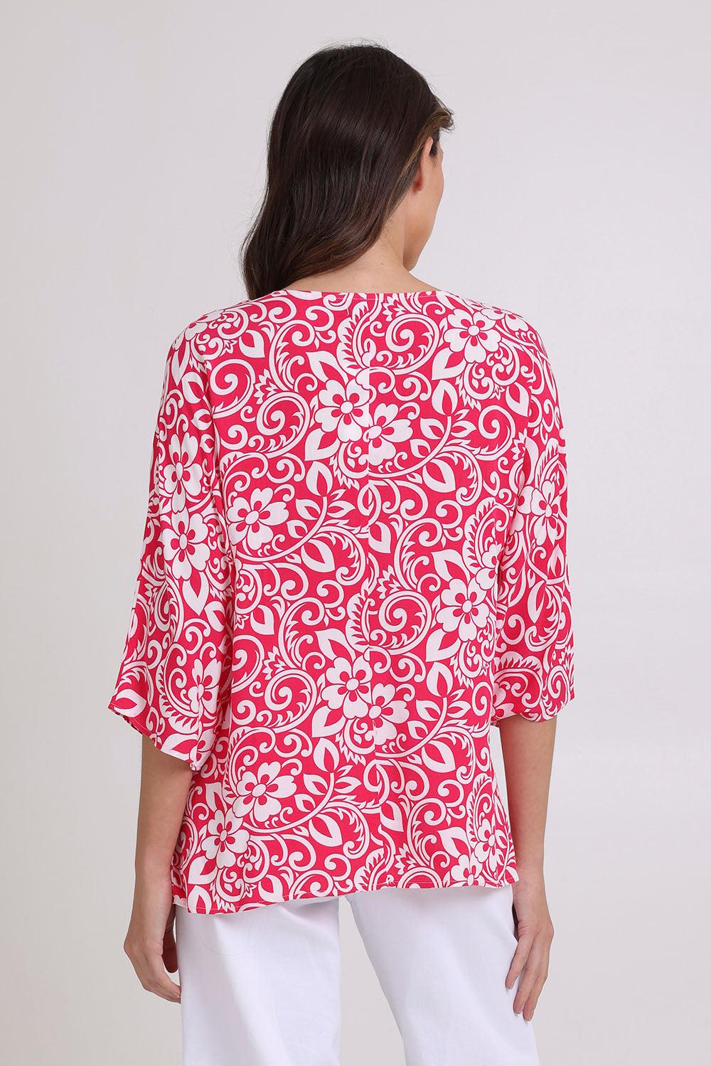 Model Madeline wearing size 10 of the Summer Ease Top in colour Raspberry (Pink), from the back
