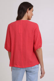Model Madeline wearing size 10 of the Victoria Textured Cotton Blend Top in colour Coral (Pink), from the back