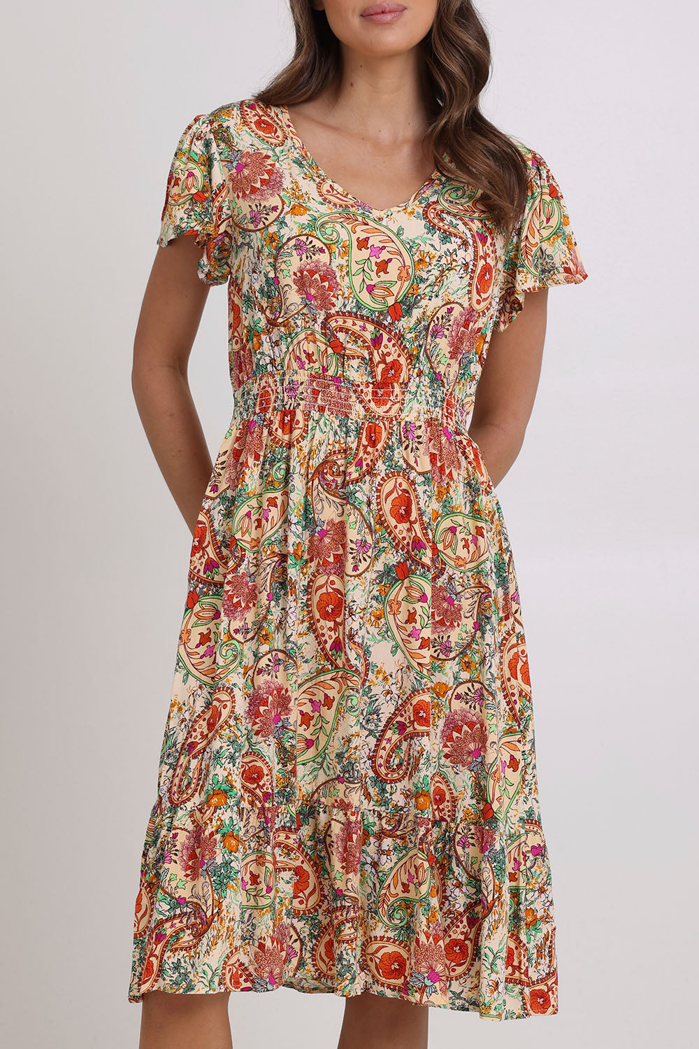 Model Madeline wearing size 10 of the Kiara Pocket Dress in colour Floral, from the front, cropped image