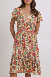 Model Madeline wearing size 10 of the Kiara Pocket Dress in colour Floral, from the front, cropped image