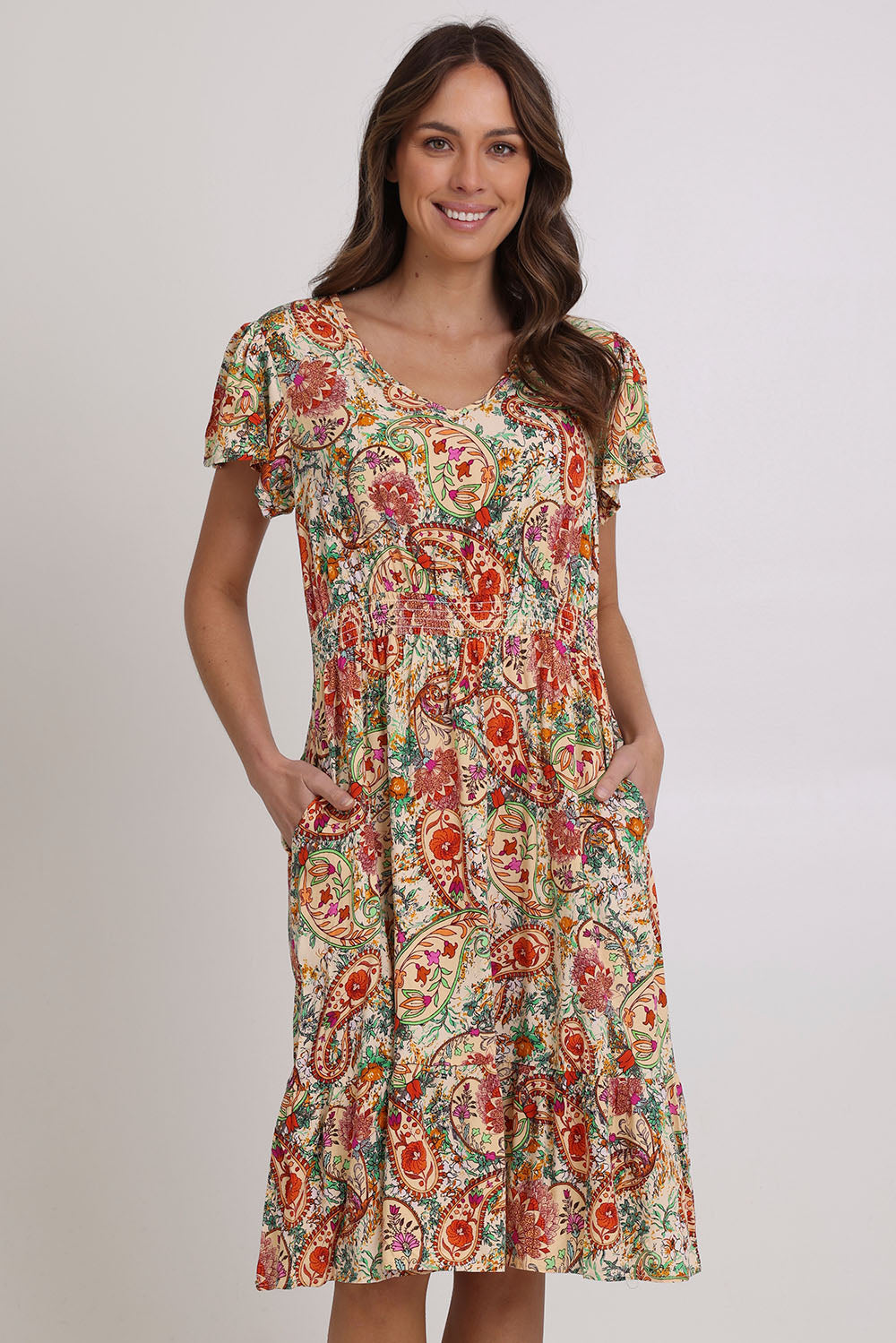 Model Madeline wearing size 10 of the Kiara Pocket Dress in colour Floral, from the front, cropped image