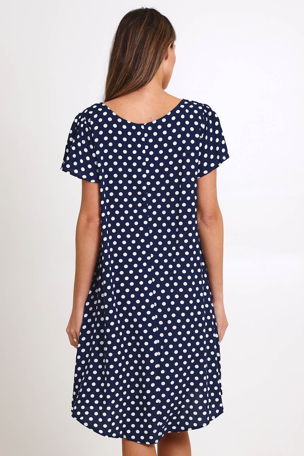 Model Madelinec wearing size 10 of the Flutter Swing Dress – Navywhite in colour Navywhite, from the back