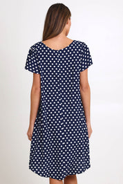Model Madelinec wearing size 10 of the Flutter Swing Dress – Navywhite in colour Navywhite, from the back