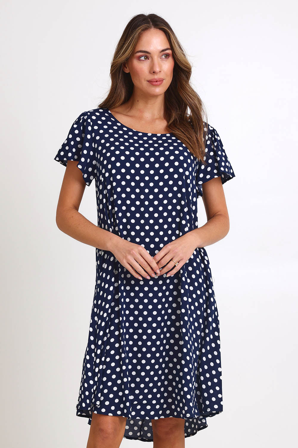 Model Madelinec wearing size 10 of the Flutter Swing Dress – Navywhite in colour Navywhite, in a cropped view