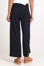 Model Madelinec wearing size 10 of the Walk And Work Pant – Black in colour Black, from the back