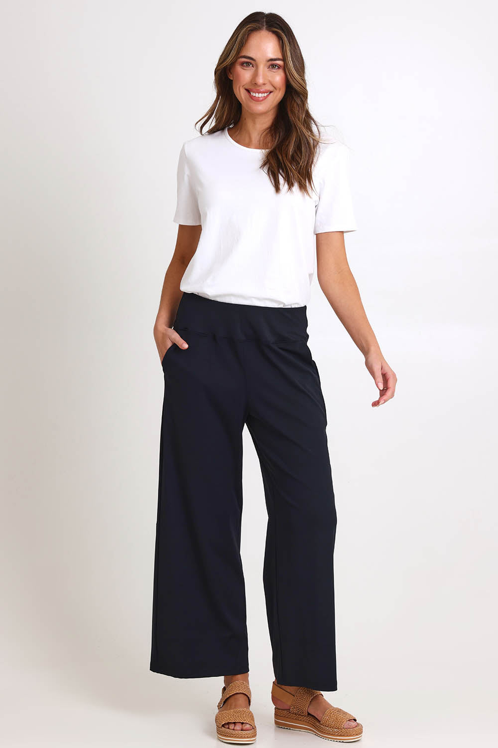 Model Madelinec wearing size 10 of the Walk And Work Pant – Black in colour Black, from the front