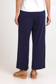 Model Madelinec wearing size 10 of the Walk And Work Pant – Navy in colour Navy, from the back