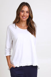 Model Madelinec wearing size 10 of the Ruffle Top – White in colour White, in a cropped view