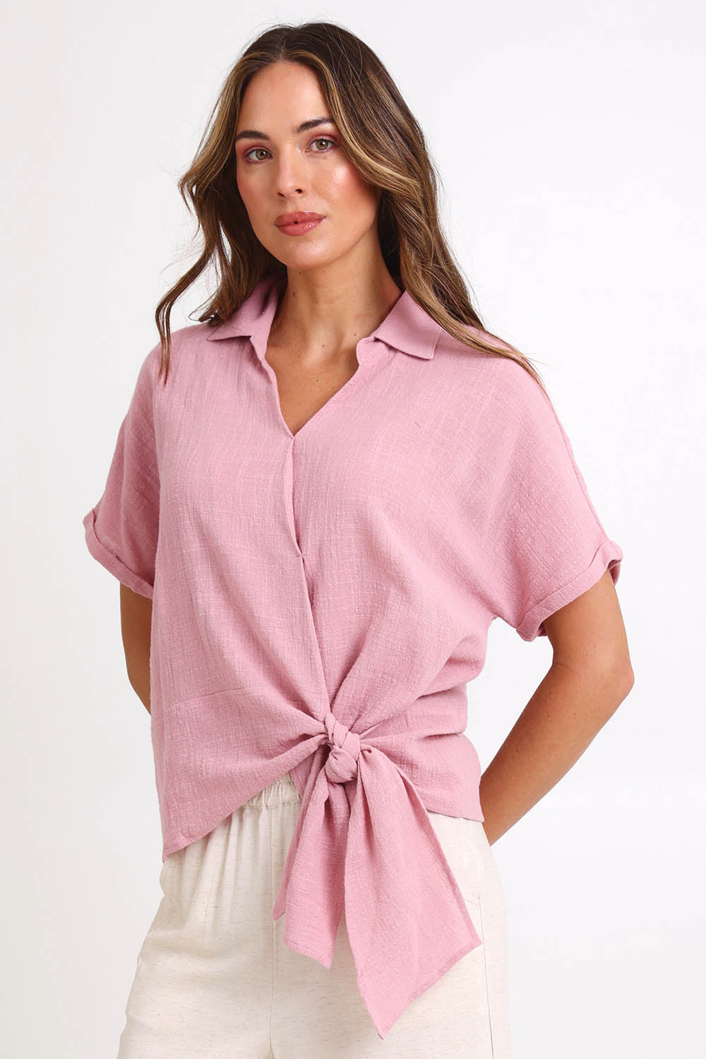 Model Madelinec wearing size 10 of the Core Wrap Over Top – Rose in colour Rose, in a cropped view