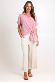Model Madelinec wearing size 10 of the Core Wrap Over Top – Rose in colour Rose, from the front