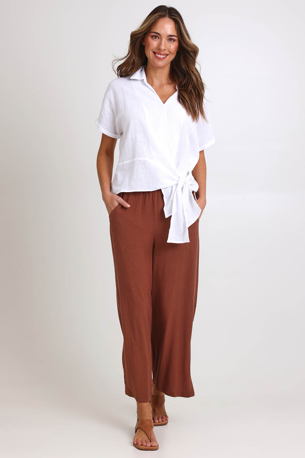 Model Madelinec wearing size 10 of the Core Wrap Over Top – White in colour White, from the front