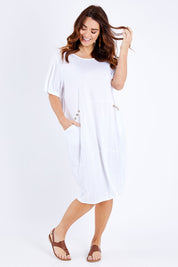 Model Laura wearing size M-L of the Happy Petals Bounce Dress in colour White (White), from the front, showing the whole outfit