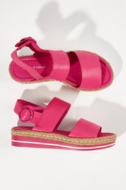 A model wearing size 38 of the Atha Sandal Flatform in colour Fuchsia (Pink), from the front, showing the whole outfit