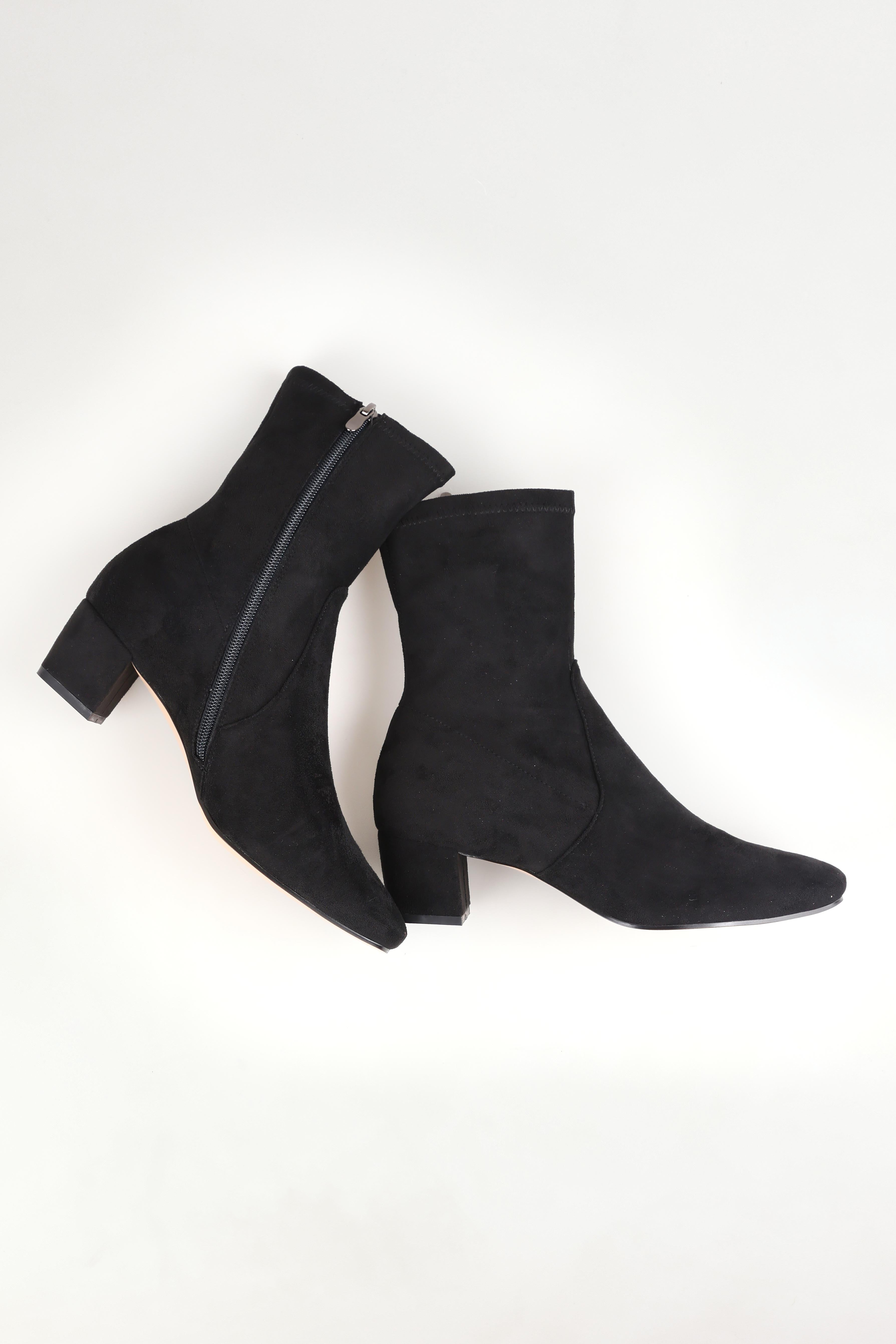 A model wearing size 37 of the Hartful Stretch Ankle Boot in colour Blackmicro (Black), from the front, showing the whole outfit