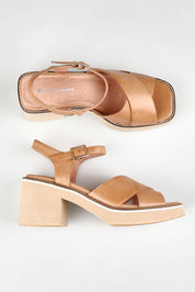 A model wearing size 37 of the Jemi Leather Heel in colour Tan, from the front, showing the whole outfit