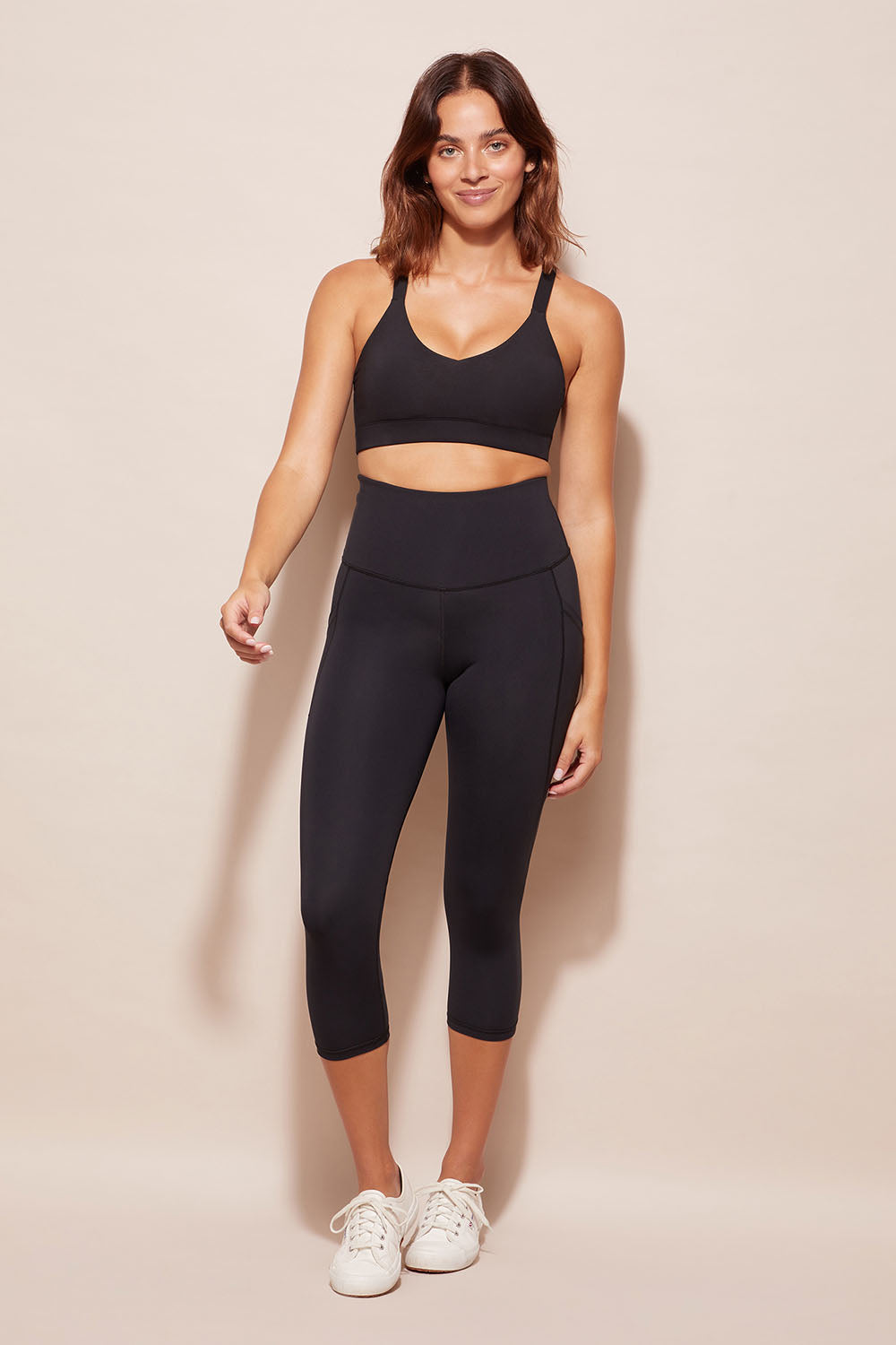 A model wearing the Essential Tight Midi in colour Black (Black), from the front, showing the whole outfit