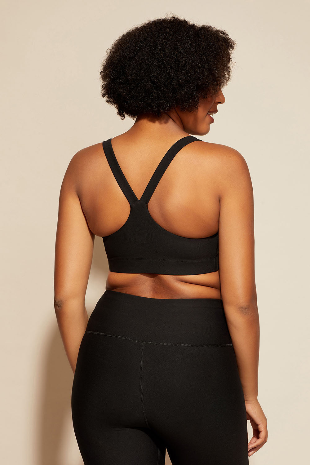 A model wearing the Say Something Crop in colour Black (Black), from the back