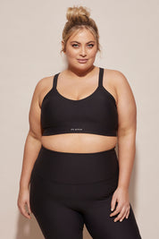 A model wearing the Say Something Crop in colour Black (Black), from the front, cropped image