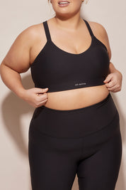 A model wearing the Say Something Crop in colour Black (Black), from the front, cropped image