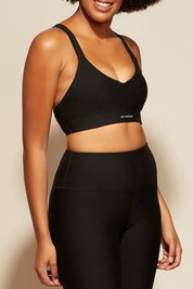 A model wearing the Say Something Crop in colour Black (Black), from the front, cropped image