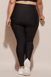 A model wearing the Elite Tight Full Length in colour Black (Black), from the back