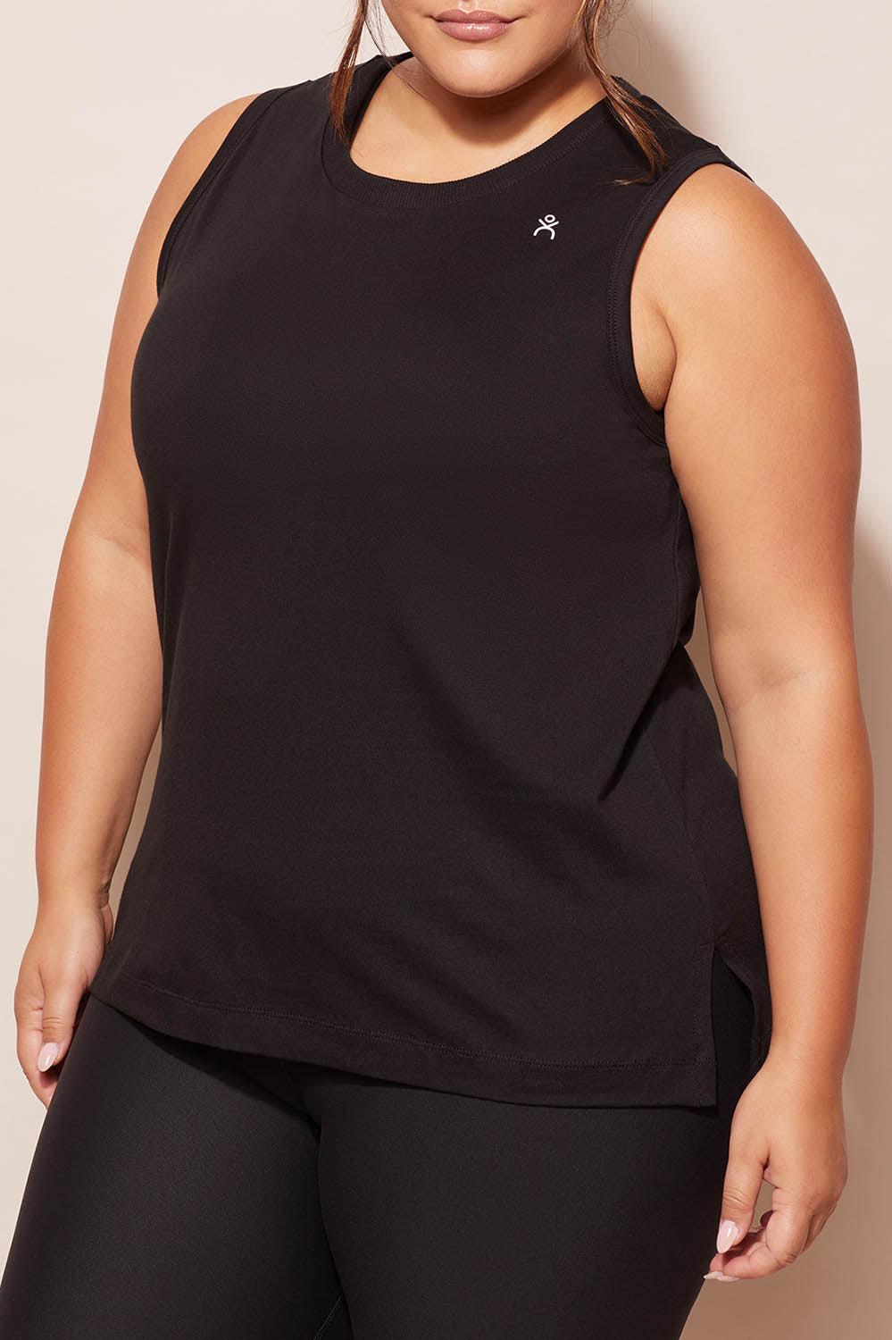 A model wearing the Champion Tank in colour Black (Black), from the front, cropped image