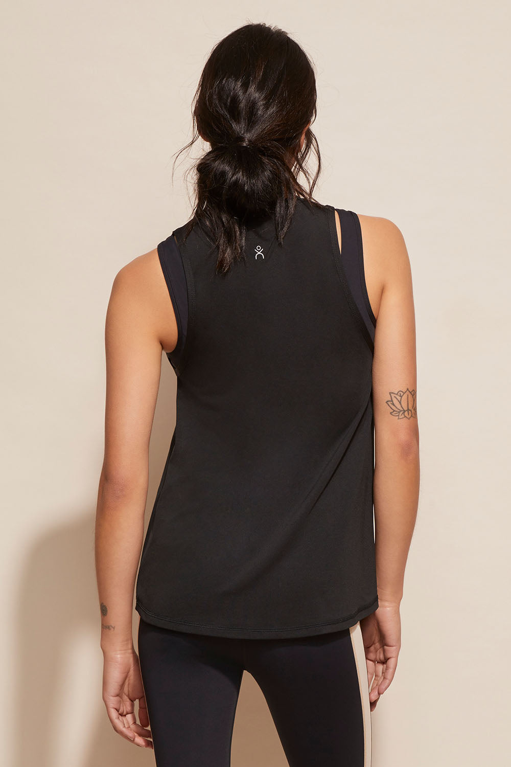 A model wearing the Worldwide Tank in colour Black (Black), from the back