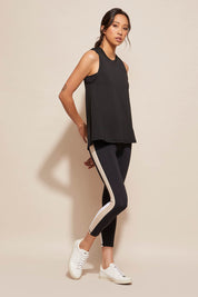 A model wearing the Worldwide Tank in colour Black (Black), from the front, showing the whole outfit