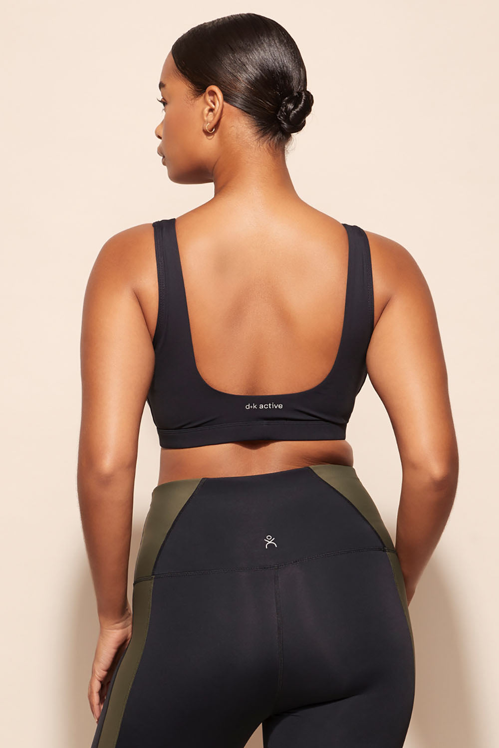 A model wearing the Lay Up Crop in colour Khakiblk (Black), from the back